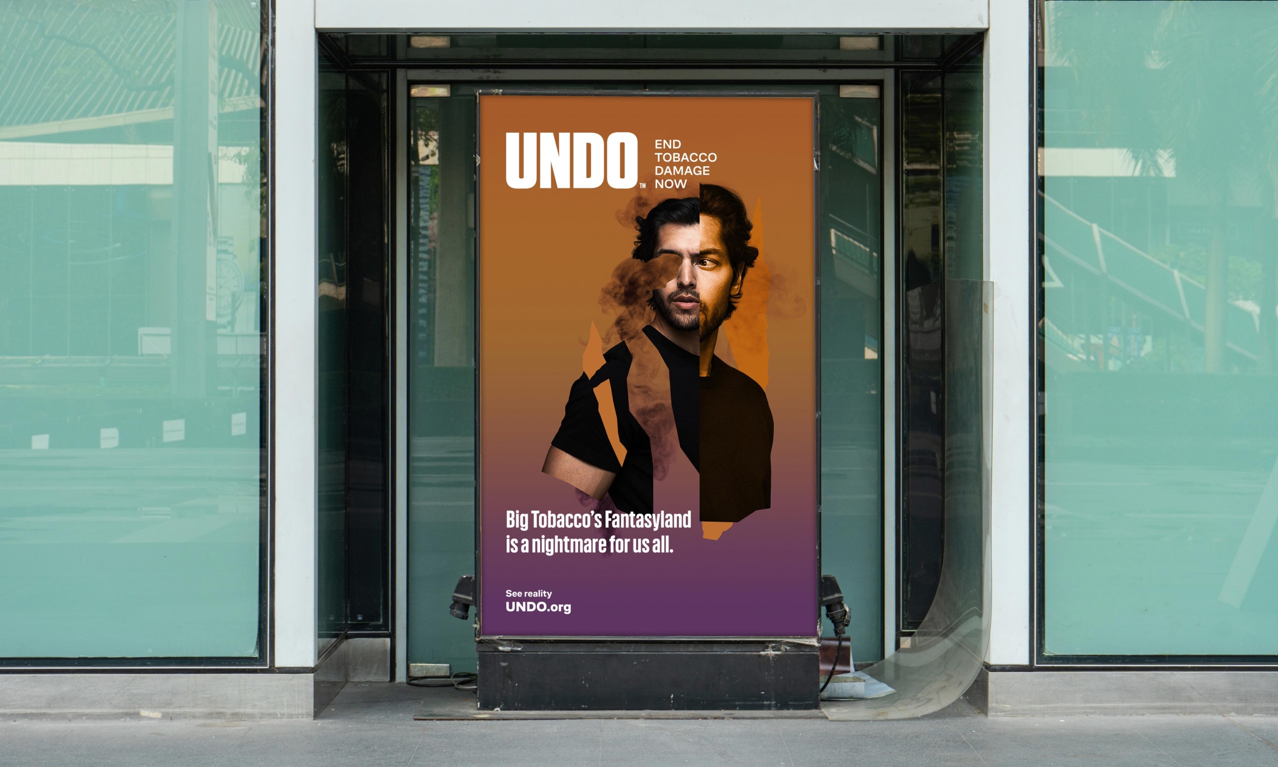 A bus shelter billboard in dark orange and purple shows a fractured collage portrait of a person trying to quit nicotine. The headline reads, “Undo. End Tobacco Damage Now. Big Tobacco’s Fantasy;and is a nightmare for us all. See Reality. Undo dot org.”